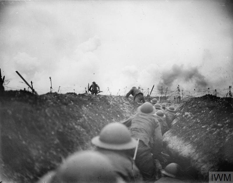 An officer of the 10th Battalion, Cameronians (Scottish Rifles) leads the way out of a sap and is being followed by the party. Note shells bursting in the distance. Near Arras, 24 March 1917. (© IWM Q 5100)